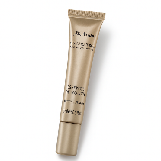 Eine goldene Tube des M. Asam Resveratrol Premium NT50 Essence of Youth Serums liegt leicht nach hinten gekippt auf weißem Hintergrund. Die schwarze Aufschrift mit Markenname und Produktdetails ist klar erkennbar, die Tube wirft einen weichen Schatten.